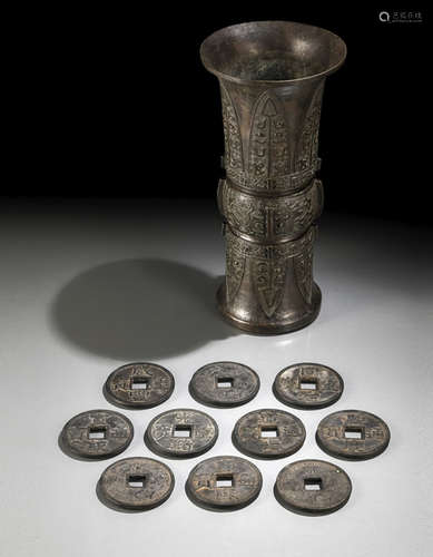 A BRONZE VASE IN ARCHAIC STYLE AND TEN BRONZE COINS