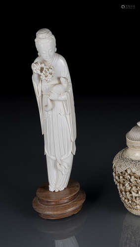 A FINE IVORY CARVING OF AN ELEGANT LADY HOLDING A SQUIRREL AND A BUNCH OF GRAPES