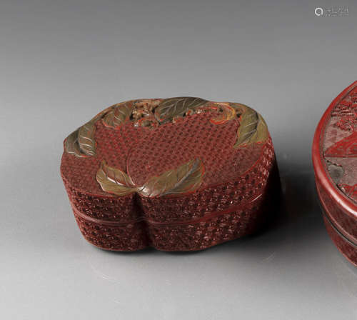 A FINE CARVED THREE-COLORED CINNABAR LACQUER PEACH BOX AND COVER