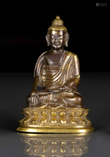 A PARCEL GILT-BRONZE FIGURE OF BUDDHA SHAKYAMUNI