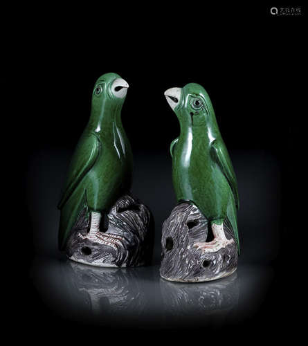 A PAIR OF GREEN AND AUBETGINE GLAZED BISCUIT PORCELAIN PARROTS