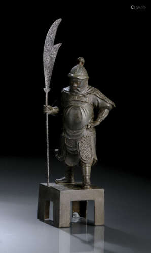 A BRONZE FIGURE OF A STANDING GUARDIAN WITH AN IRON HALBERD