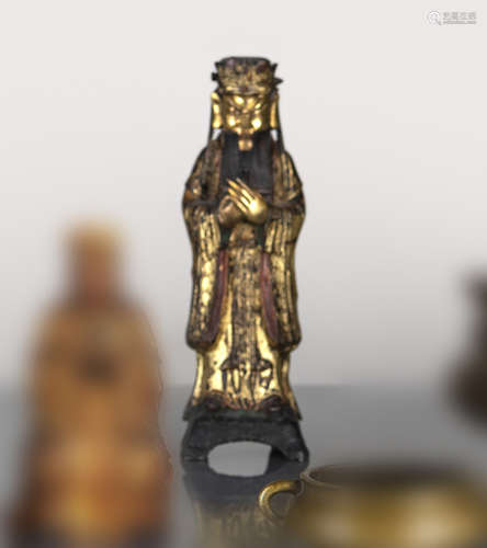 A GILT-LACQUERED BRONZE FIGURE OF A STANDING OFFICIAL