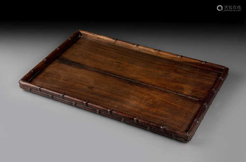 A CARVED HARDWOOD TRAY WITH BAMBOO-STYLE CRAVED RIM