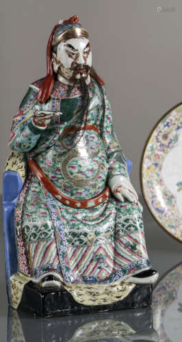 A POLYCHROME DECORATED PORCELAIN MODEL OF A SEATED OFFICIAL