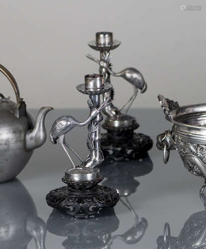 A PAIR OF SILVER BAMBOO AND EGRET CANDLE HOLDERS