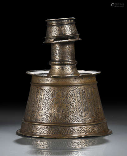 A BRONZE CANDLE HOLDER WITH SILVER INLAYS