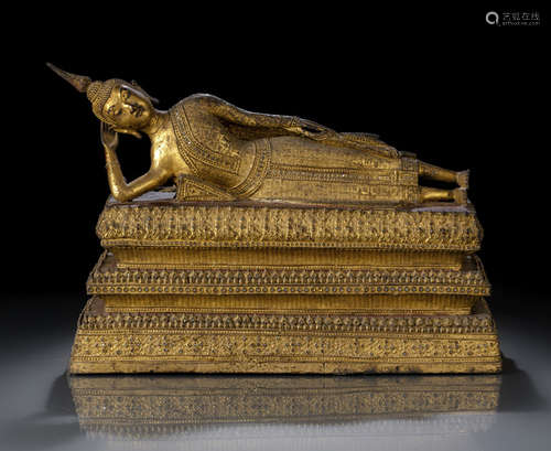 A GILT- AND RED-LACQUERED BRONZE FIGURE OF THE BUDDHA PARANIRVANA