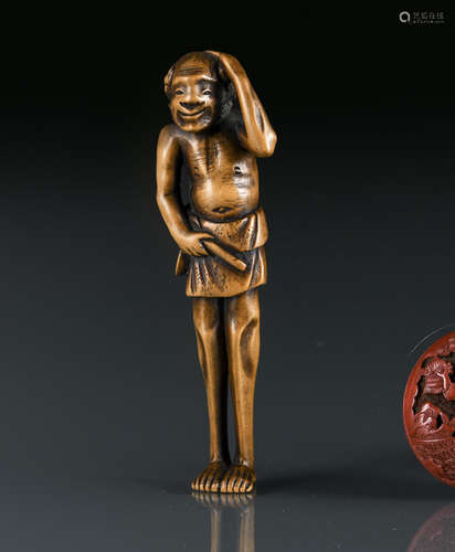 A CARVED WOOD NETSUKE OF STANDING ASHINAGA