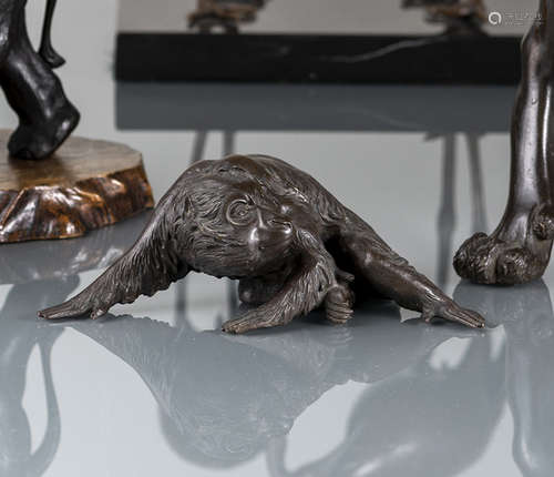 A BRONZE MODEL OF A SEATED MONKEY