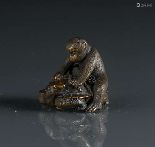 A FINE CARVED WOOD NETSUKE OF A MONKEY SEATED ATOP A TORTOISE