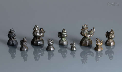 A GROUP OF NINE BRONZE BIRD- OR ANIMAL-SHAPED OPIUM WEIGHTS
