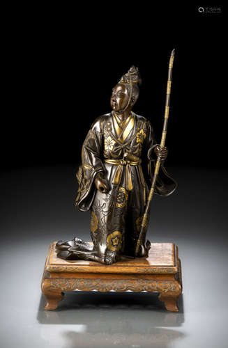 A PARCEL-GILT BRONZE FIGURE OF A STANDING COURTIER