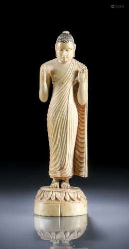 A WELL CARVED IVORY MODEL OF STANDING BUDDHA
