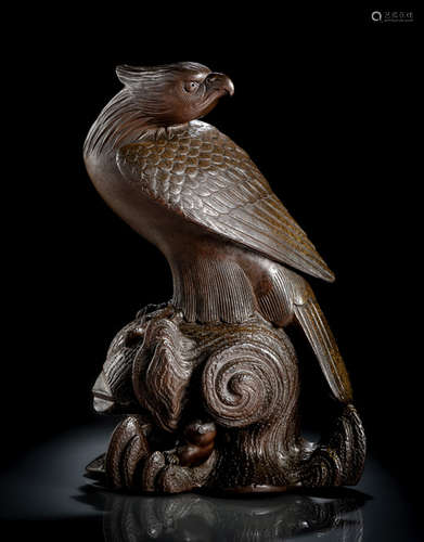 A BIZEN KORO IN SHAPE OF A FALCON PERCHED ON A TREE TRUNK WITH A MONKEY HIDING UNDERNEATH