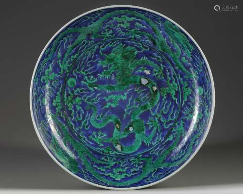 A Chinese green-enamelled blue ground 'dragon' charger