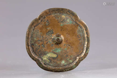 A Chinese four-lobed bronze mirror