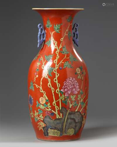 A Chinese red ground famille rose vase