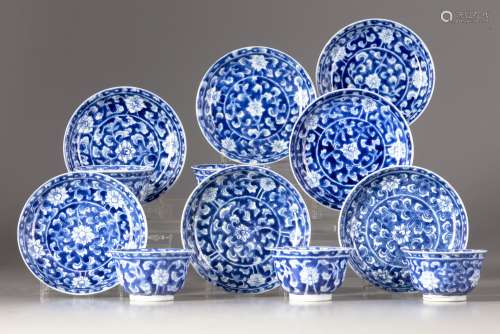 Five blue and white cups and seven saucers
