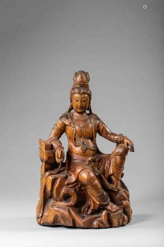 Le Boddhisattva Kwan Yin Avalokitésvara assis en délassement sur un rocher vêtu [...]
