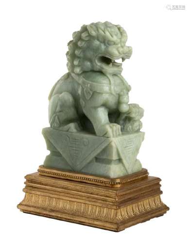 A CARVED GREEN HARDSTONE BUDDHIST LION China, 20th