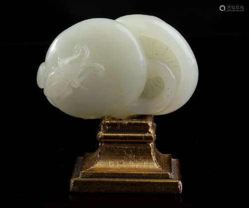 A WHITE JADE CARVING WITH TWO MUSHROOMS AND AN INSECT