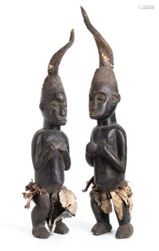 A PAIR OF WOOD, TEXTILE, HORN AND METAL BELLS FIGURES