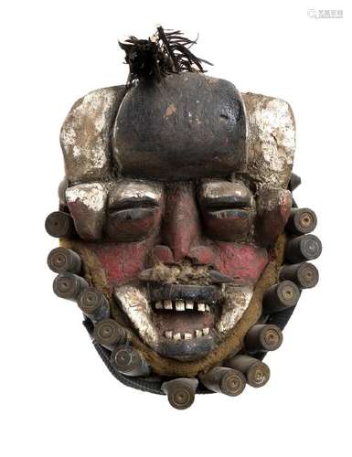 A PAINTED WOOD, NAILS, FEATHERS AND CASES MASK Ivory