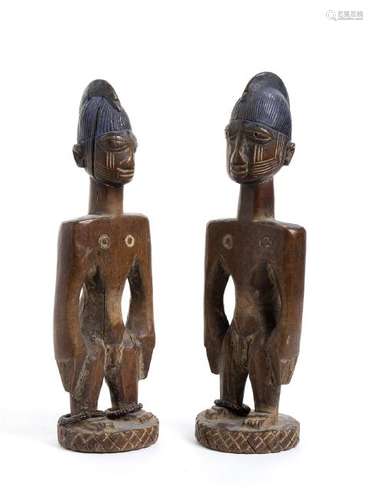 A PAIR OF YORUBA PAINTED WOOD 'ERE IBEJI' Nigeria,