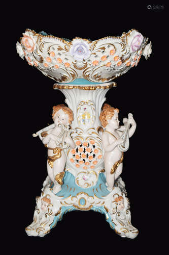 A Continental Porcelain Four Musical Cherub Compote