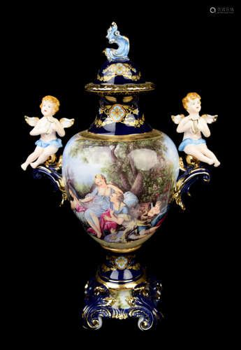 A Continental Indigo Porcelain Lidded Urn with Angel Handles