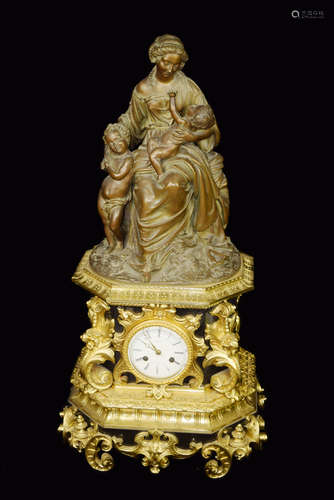 A Mental Clock with Gilt Bronze edge and Bronze Statue of Mother and Children