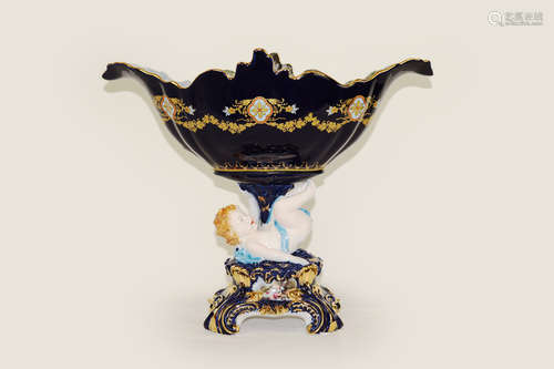 A Continental Indigo Porcelain lily Shape Compote with a Cherub Support