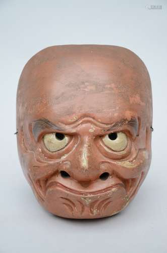 A red-brown Japanese mask in wood