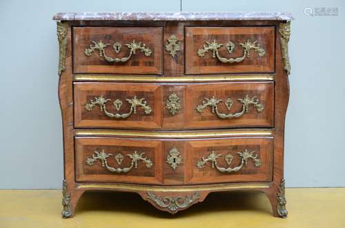 A Louis XV chest of drawers with a red marble top