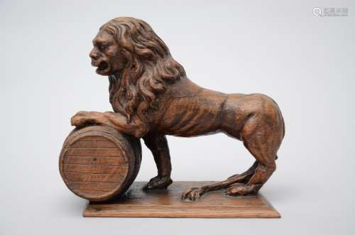 Oak sculpture 'lion with beer barrel'