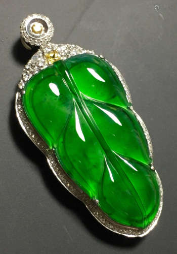 A GREEN JADEITE CARVED LEAF PENDANT, TYPE A