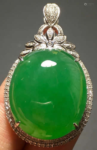 A GREEN JADEITE CARVED CIRCLE PENDANT, TYPE A