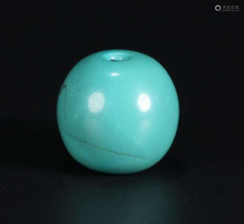 A TURQUOISE STONE BEAD