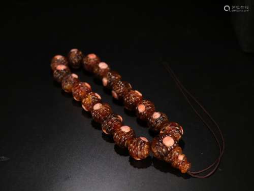 A Chinese Carved Amber and Coral Bracelet