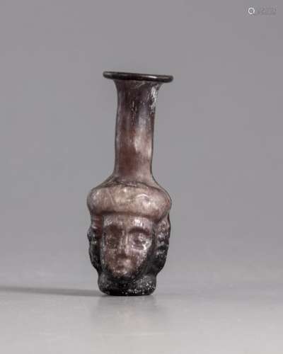 A Roman glass head flask