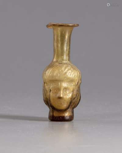 A Roman glass head flask