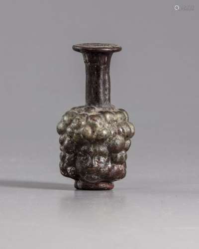 A Roman purple glass head flask