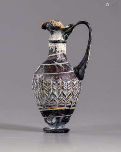 A Roman trefoil lipped purple glass jug