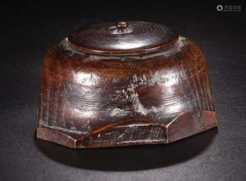 A RED WOOD SHAPED CARVED JAR WITH LID