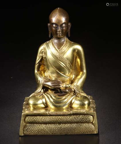 A GILT BRONZE FIGURE OF A SEATED BUDDHA