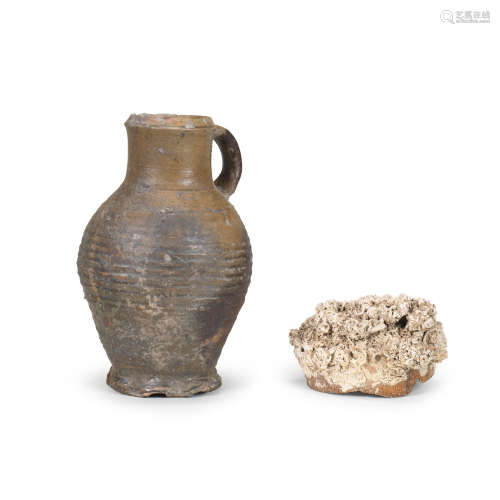 A Rhineland stoneware jug, 15th century, together with an encrusted stoneware shard