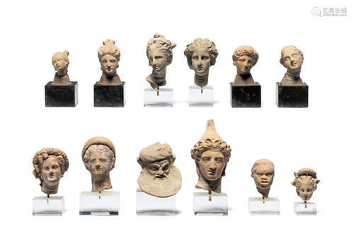 Twelve small Greek terracotta heads  12