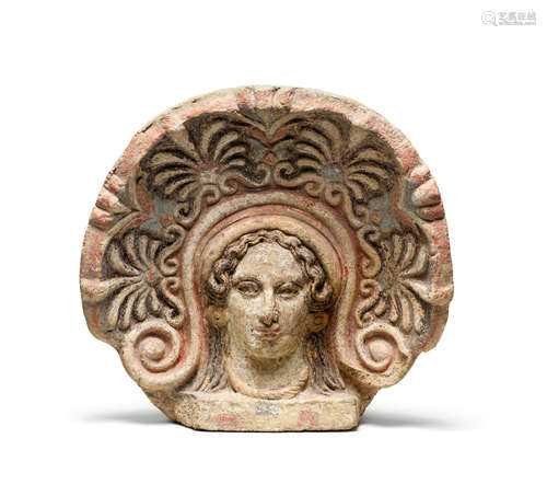 An Etruscan terracotta antefix with polychrome decoration