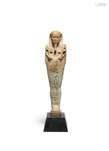 An Egyptian pale green glazed composition shabti for Sa-Iset